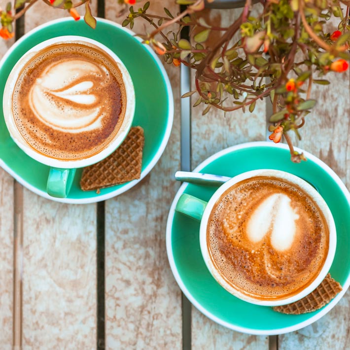 A close-up of a velvety cappuccino made with San Pietro di Puglia beans, showcasing the rich foam and peak freshness of an authentic Italian roast.